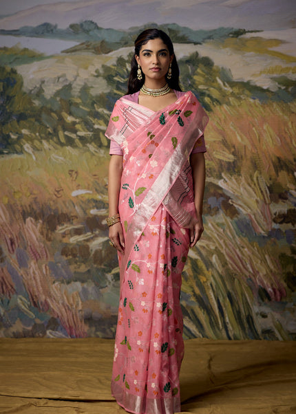 Luxury pink handwoven Kota saree with floral jaal, silver zari stems, nature-inspired floral motifs, silver zari chevron pallu, minimal silver zari border and premium festive designer craftsmanship by Sonchiraiya