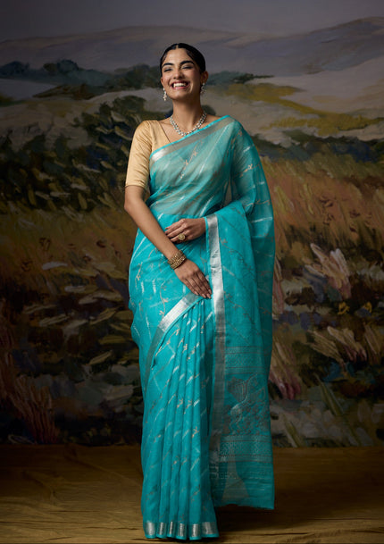 Luxury sky blue handwoven Kota saree with gold and silver zari vine weave, flying unicorn motif pallu, minimal silver zari border and premium festive designer craftsmanship by Sonchiraiya