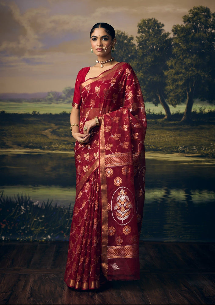 Luxury maroon handwoven Kota saree with gold zari floral jaal, silver zari accents, Mughal floral pallu, minimal gold zari border and premium festive wedding designer craftsmanship by Sonchiraiya