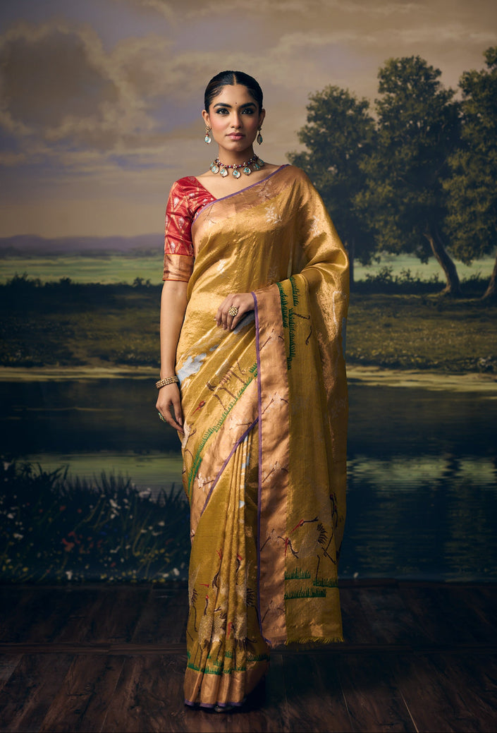 Luxury olive green handwoven Kota double gold tissue saree with silver zari crane and cloud motifs, nature-inspired storytelling weave, artistic crane pallu, gold zari border and premium festive heritage designer craftsmanship by Sonchiraiya