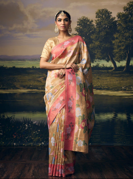 Luxury beige gold handwoven Kota double gold tissue saree with Chinese floral jaal, bird and crane motifs, silver zari detailing, artistic crane pallu, contrast peach pink floral border and premium festive heritage designer craftsmanship by Sonchiraiya