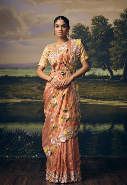 Luxury pastel peach handwoven Kota gold tissue saree with gold zari chevron weave, Paithani Pushpa Chakra floral pallu, embroidered floral border and premium festive heritage designer craftsmanship by Sonchiraiya