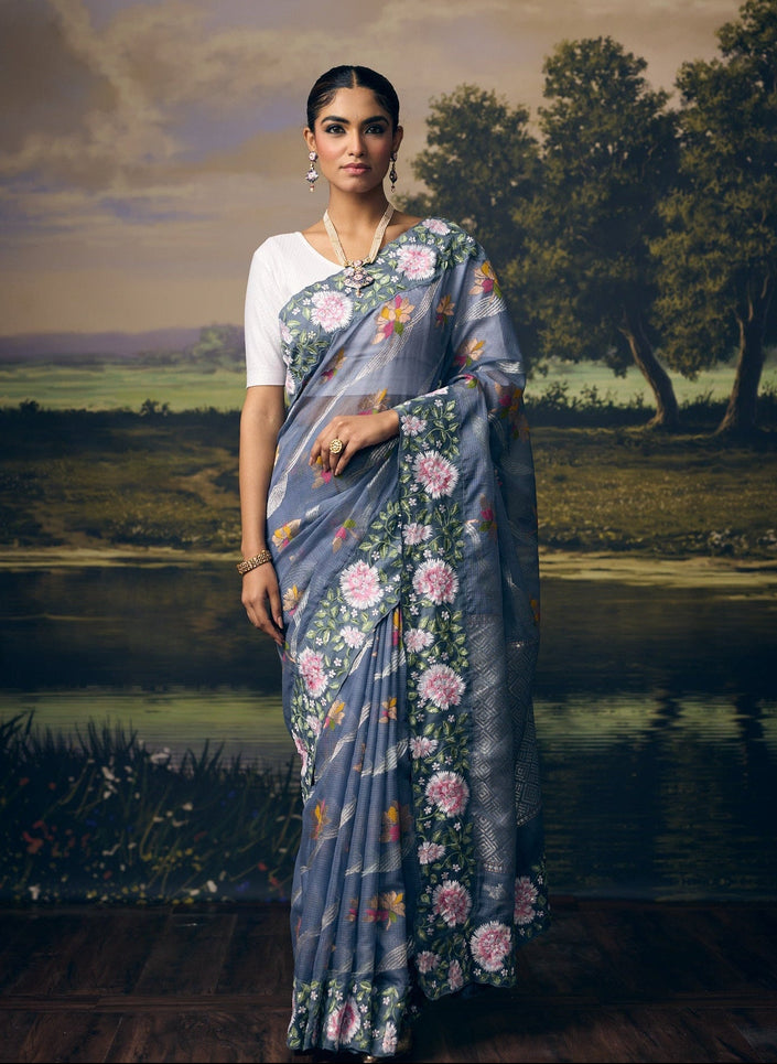 Luxury grey handwoven Kota saree with silver zari wavy weave, multicolour floral motifs, gold zari accents, silver zari Jamawar check pallu, embroidered sequin border and premium festive designer craftsmanship by Sonchiraiya