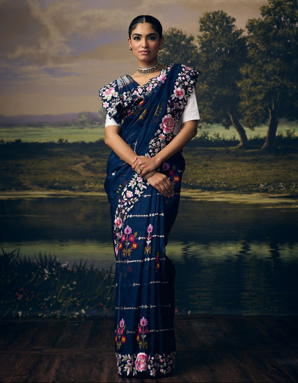 Luxury navy blue handwoven Kota saree with gold and silver zari striped weave, multicolour floral vines, Jamawar check pallu, embroidered floral border and premium festive designer craftsmanship by Sonchiraiya