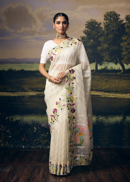 Luxury off white handwoven Kota saree with silver zari Laheriya weave, delicate floral booti, multicolour floral bouquet pallu, embroidered garden border and premium festive designer craftsmanship by Sonchiraiya