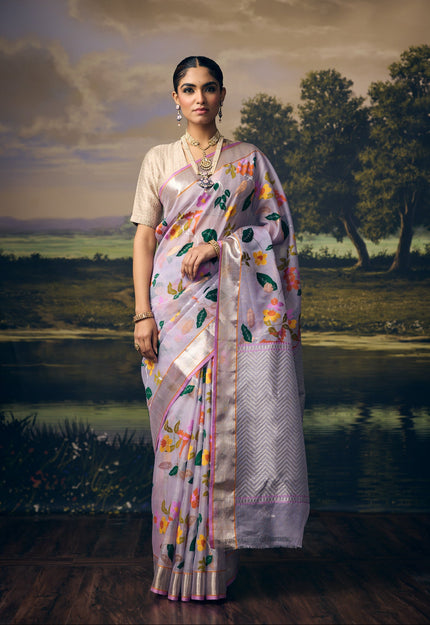 Luxury lavender handwoven Kota saree with multicolour floral jaal, gold and silver zari weaving, silver zari chevron pallu, minimal silver border and premium festive designer craftsmanship by Sonchiraiya
