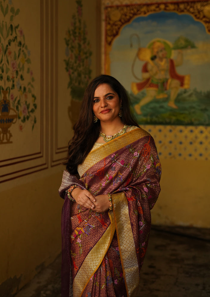 Luxury maroon handwoven Kota Jamawar saree with gold zari geometric buti weave, multicolour floral pallu, contrast mustard zari border and premium festive heritage designer craftsmanship by Sonchiraiya